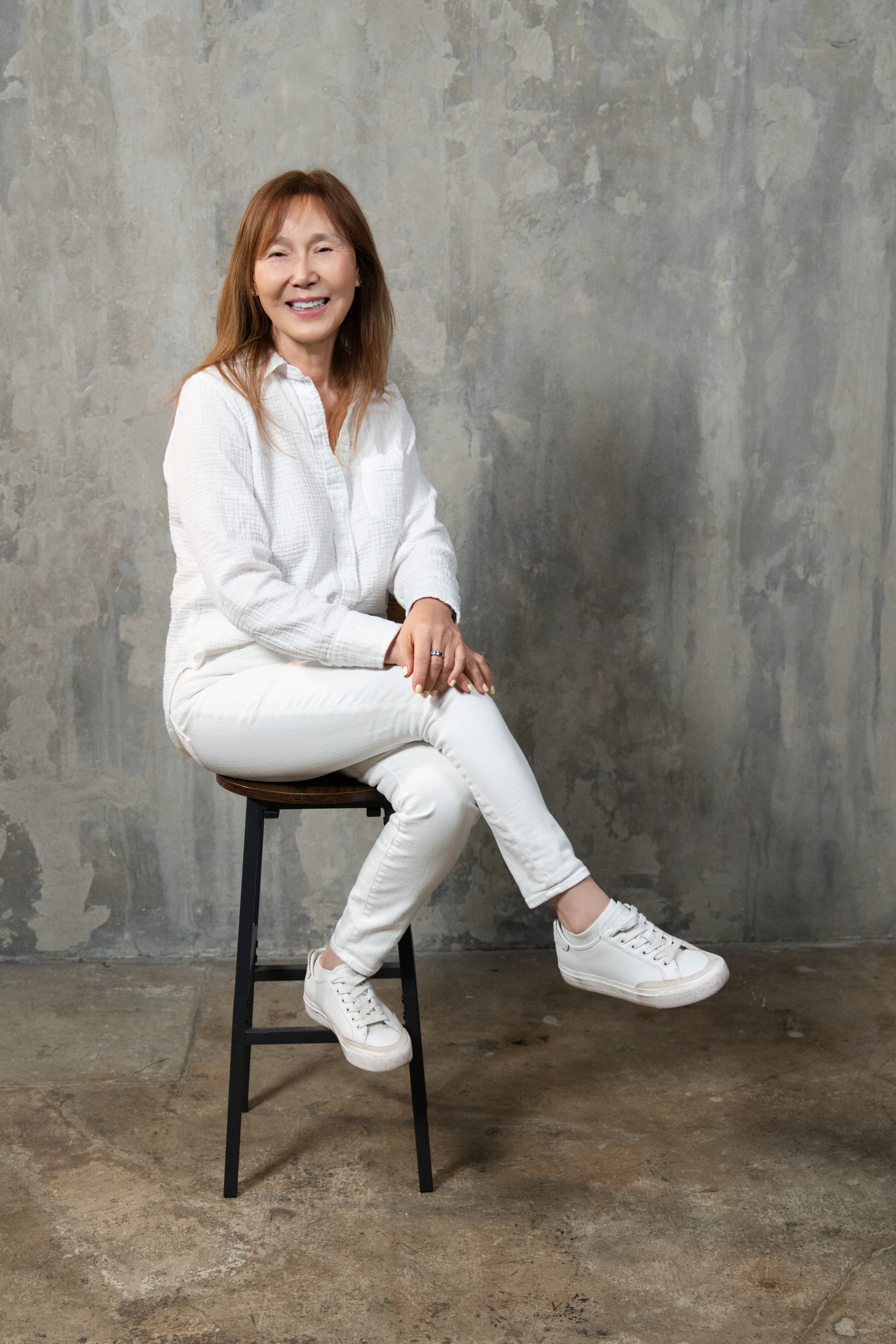 Angela An seated, smiling